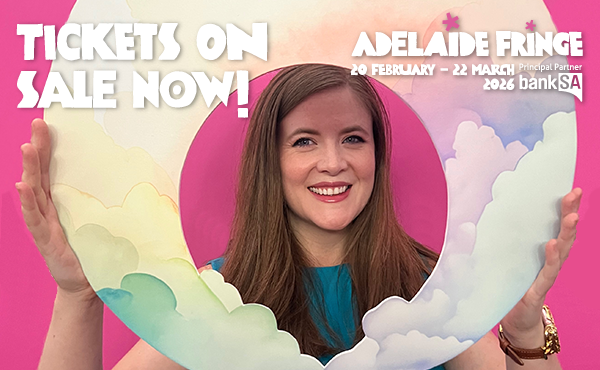 Joanne Hartstone holds her rainbow clouds logo against a pink background